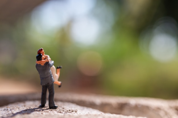 Miniature people :  Couple standing in the park