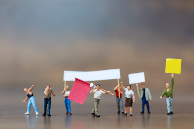 Miniature people , Crowd of protesters people raised hands and shouting