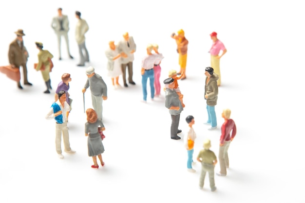 Miniature people different people stand on a white background communication of society of different generations