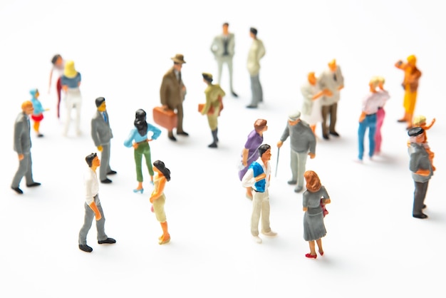 Miniature people different people stand on a white background communication of society of different generations