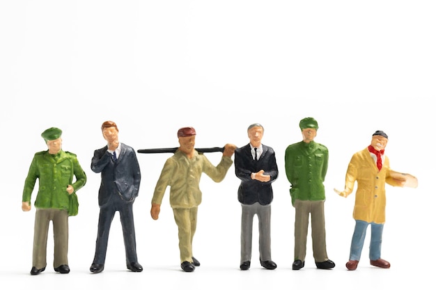 Photo miniature people different professions standing on white background labour day concept