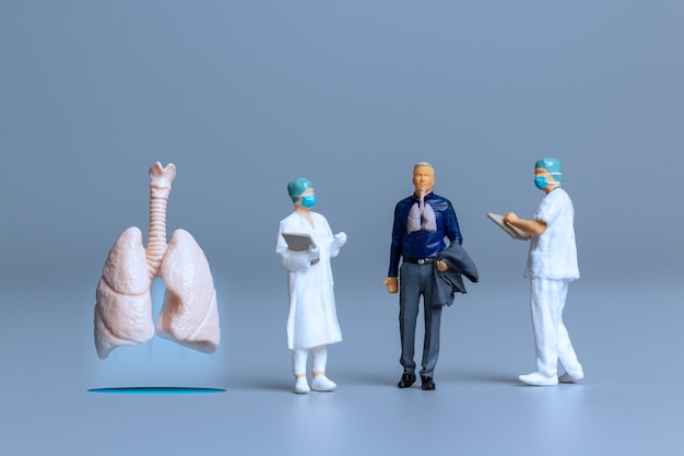 Miniature people  Doctors study and treat large human lungs World Health Day concept