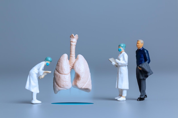 Miniature people  Doctors study and treat large human lungs World Health Day concept