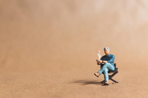 Miniature people drinking hot coffee and space for text International coffee day concept