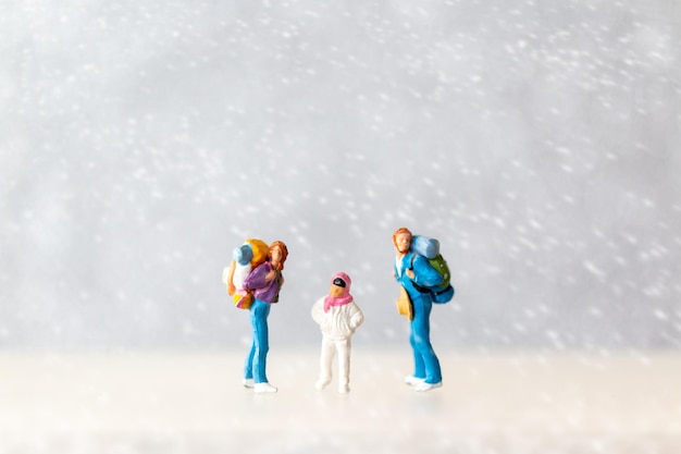 Miniature people Happy family Travel in winter time