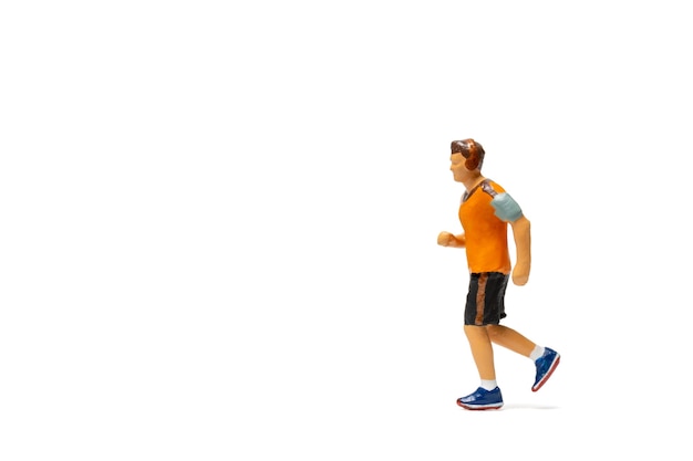 Miniature people, Man in fitness wear running on white background and space for text