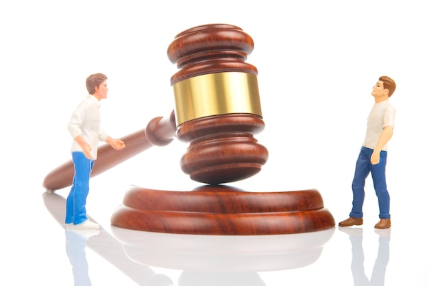 Miniature people people solve dispute and relationship near gavel of law and justice Laws to ensure the life of the society of the country