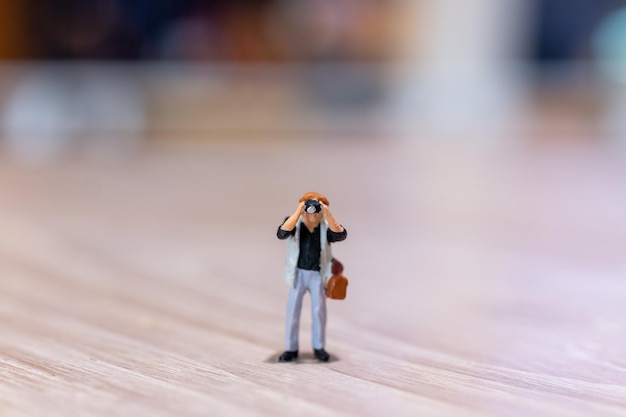 Miniature people Photography holding a camera and copy space for text