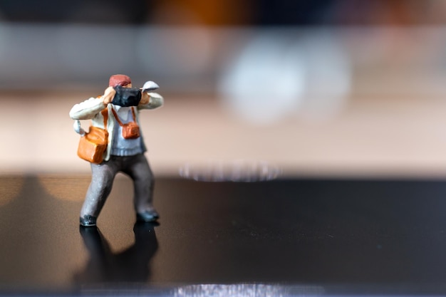 Miniature people Photography holding a camera and copy space for text