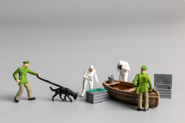 Premium Photo  Miniature people Police And Detective are working on the  boat Crime scene investigation concept