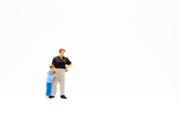Miniature people standing on white background