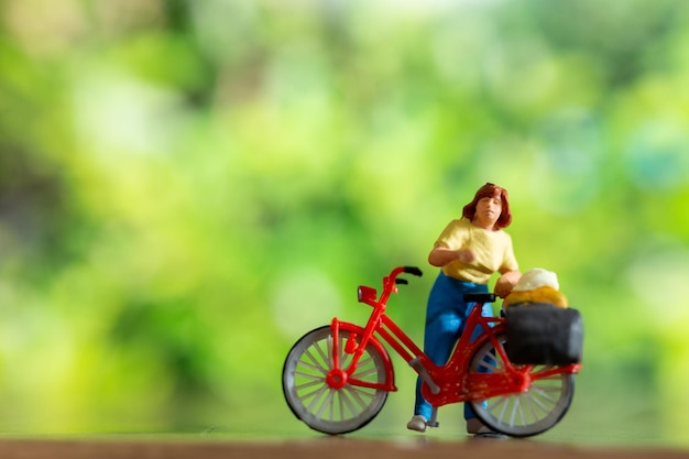 Miniature people standing with bike World bicycle day concept