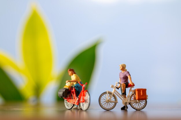 Miniature people standing with bike World bicycle day concept