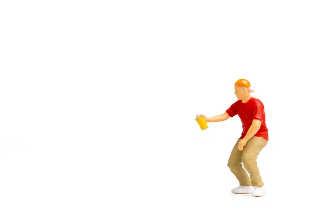 Miniature people Teenager spraying paint from can on white background and space for text