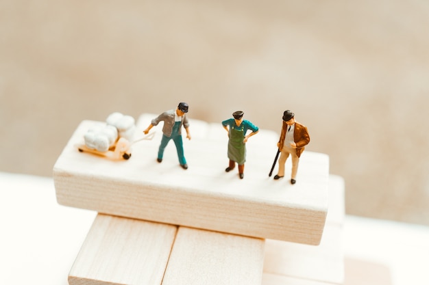 Miniature people, top view of man standing on work site, using for logistic and business concept - V