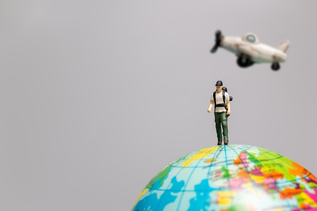 Miniature people Travelers with airplane and globe , Travel and Adventure concepts