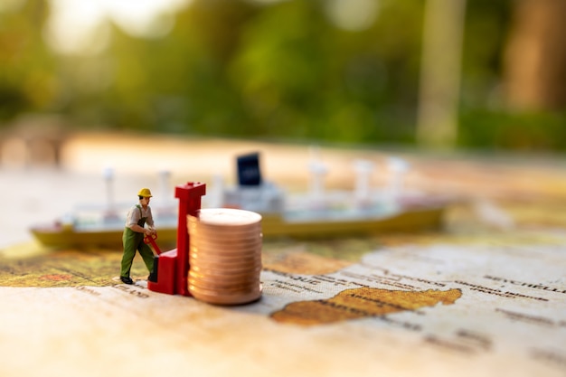 Miniature people:  Worker loading coins  to ship. Shipping and online delivery service concept.