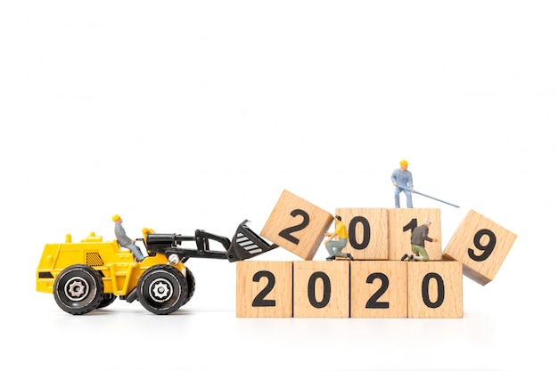 Miniature people : Worker team create wooden block number 2020