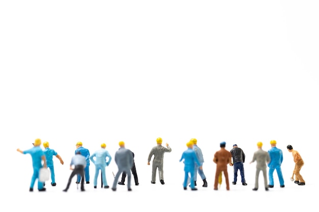 Miniature people Worker team standing on white background Labour day concept
