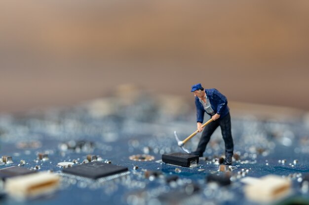 Miniature people working on CPU board