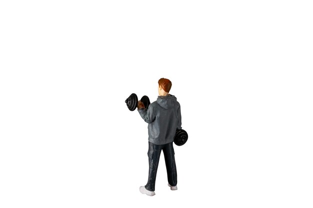 Miniature people Young man lifting weights Isolated on white background with clipping path