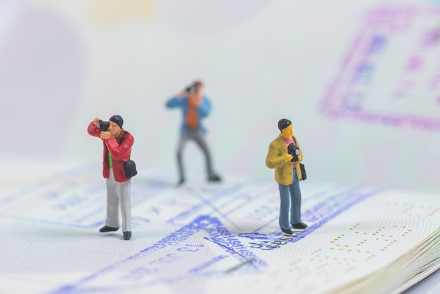 miniature photographer on passport book