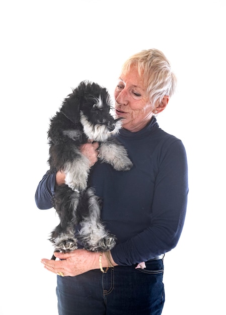 miniature schnauzer and woman in front of white background