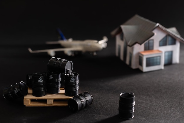 ミニチュアのおもちゃの樽と飛行機。ビジネスと金融の概念。