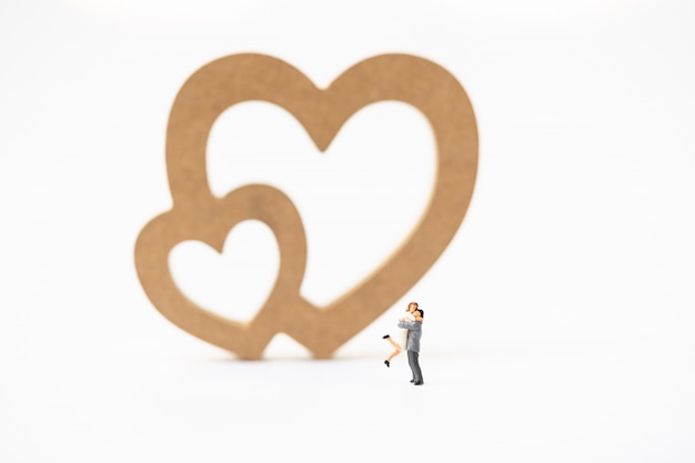 Miniature of a women and a man in love in front of heart sign with copyspace