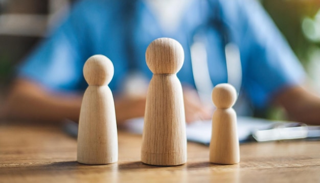 miniature wooden family figures on a doctors table symbolizing unity and healthcare support in a c