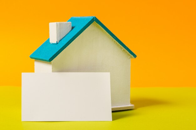 Miniature wooden house, symbol, with business card