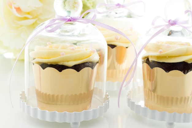 Miniatuur cupcakes in individuele glazen standaards.