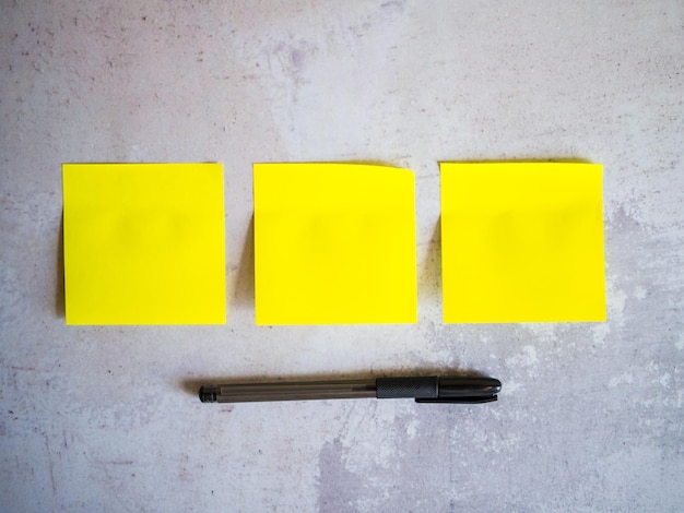 Minimal composition with sticky notes on gray concrete\
background and space for text