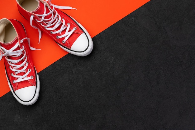 Minimal composition with summer footwear on black and red background