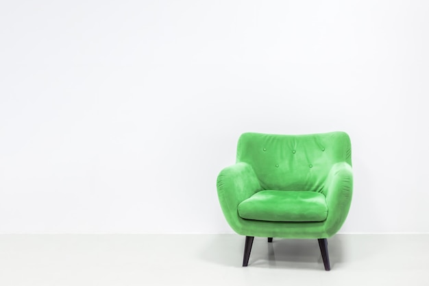 Minimal concept of interior with green armchair