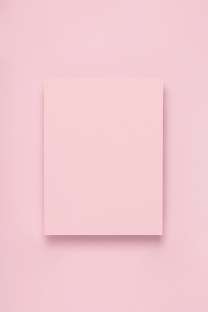 Minimal frame of pink paper on delicate pastel background.