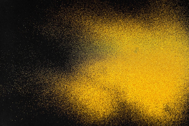 A minimal golden sand texture on a black background