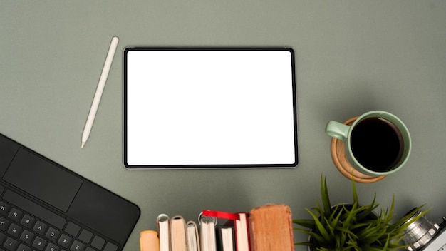 minimal office desk workspace with digital tablet white display and accessories on grey background