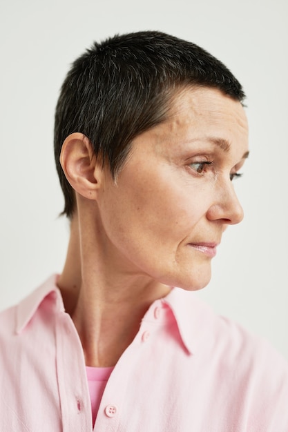 Minimal side view portrait of confident mature woman with short haircut looking away, real beauty, recovery concept