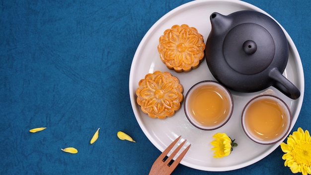 Minimal simplicity layout moon cakes on blue background for MidAutumn Festival creative food design concept top view flat lay copy space