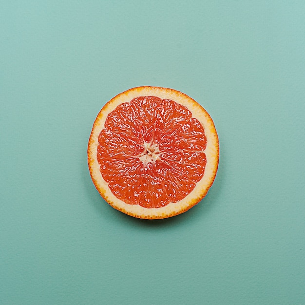 Minimal style, creative layout orange and grapefruit  on turquoise background