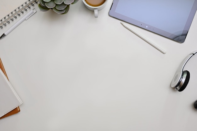 minimal white office desk workspace top view with copy space and surrounded with office supplies