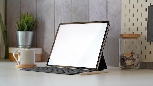 Minimal workplace with mockup blank screen tablet