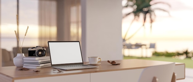 Minimal workspace with laptop mockup on table over blurred background of beautiful outdoor view