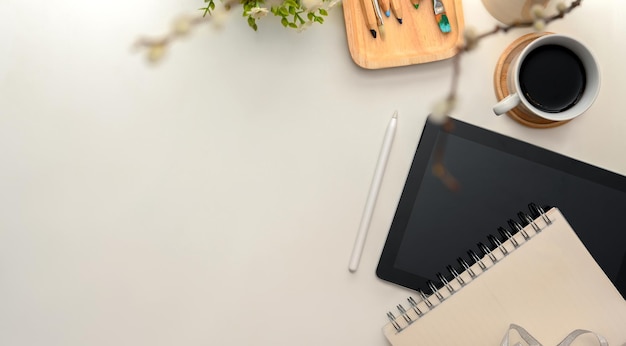 Minimal workspace with office equipments, decor and copy space on white background. top view