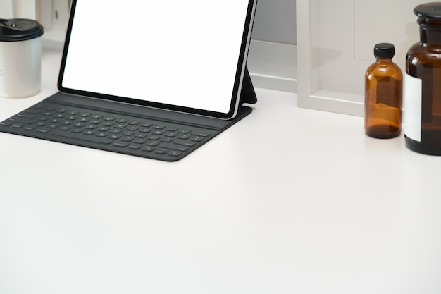 Minimal workspace with tablet and smart keyboard