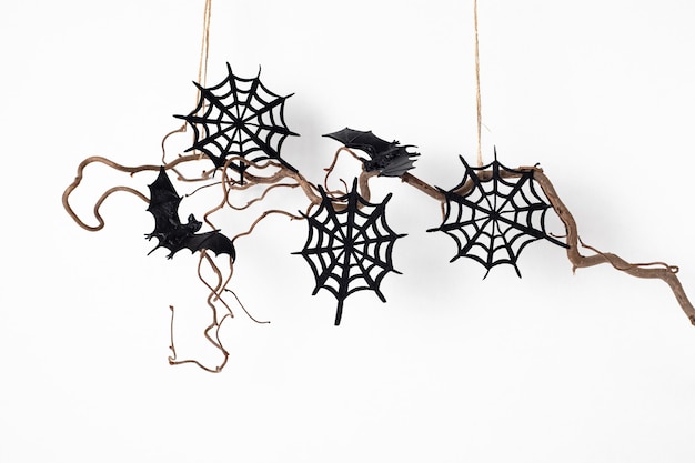 Minimale Halloween-decoratie die op geïsoleerde boomtak hangen