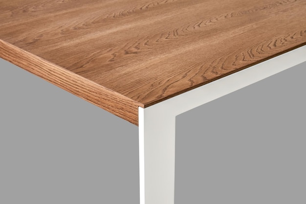 Minimalism style dining table with thin wooden table top of toned oak veneer on white metal legs