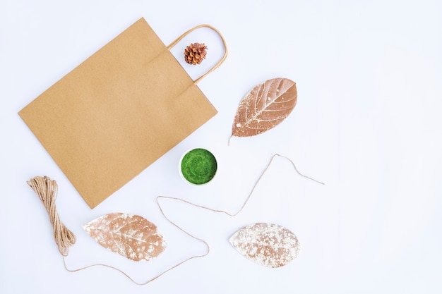 Minimalist Autumn Concept. Paper Bag, Flowerpot, Burlap Yarn Isolated On White Paper Background