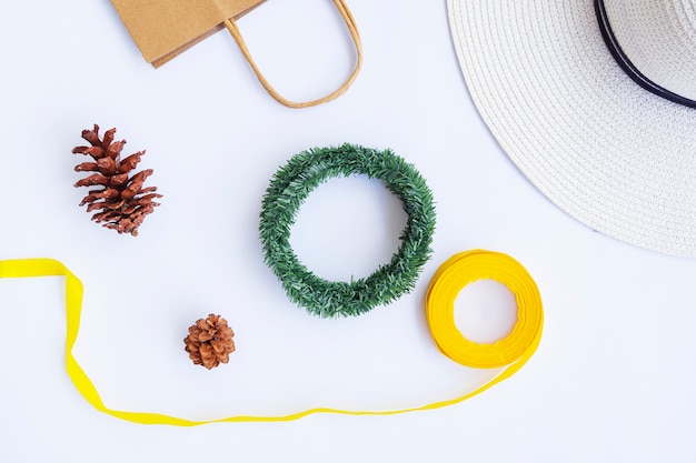 Minimalist Autumn Concept. Paper Bag, White Hat, Ribbon Rope, Pine Flowers, Krans Wreath Isolated On White Paper Background. Minimalist Christmas Concept